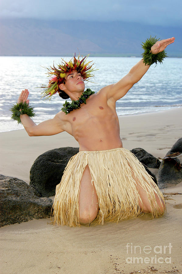 Young male hula dancer in a traditional Hawaiian hula pose.  Photograph by Gunther Allen
