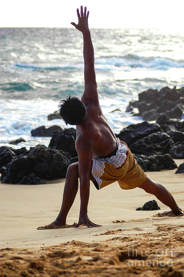Young male performs yoga moves at Little Beach on Maui, Hawaii.  Photograph by Gunther Allen