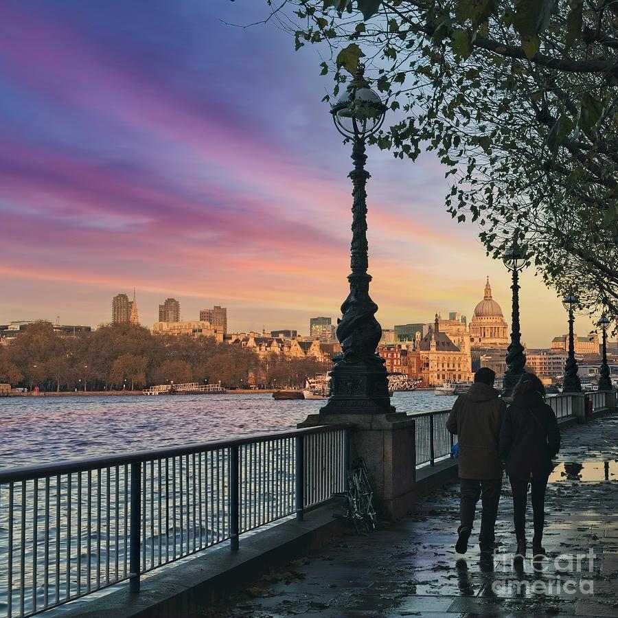 Young Man And Woman Walking Along River Thames Pathway At Sunset, London, UK Photograph by Philip Preston