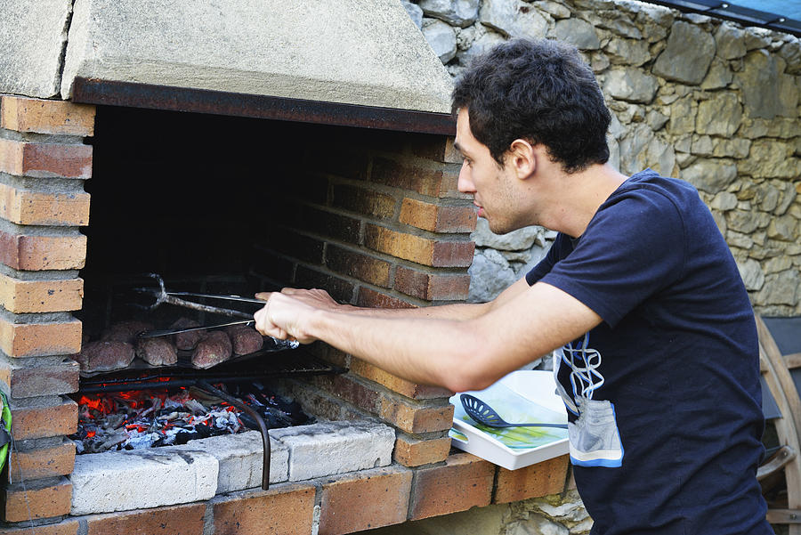 Young man at barbecue Photograph by Sami Sarkis
