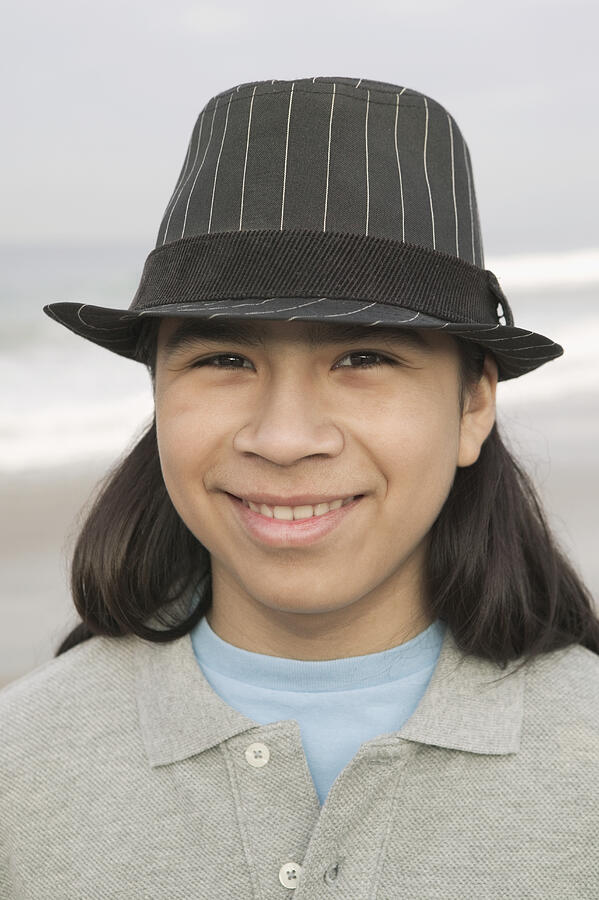 Young man at beach, smiling, portrait, close-up Photograph by Ronnie Kaufman
