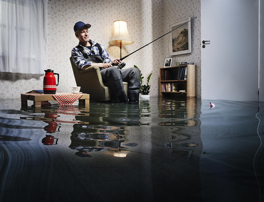 Young Man Fishing In Flooded Room Photograph by Henrik Sorensen