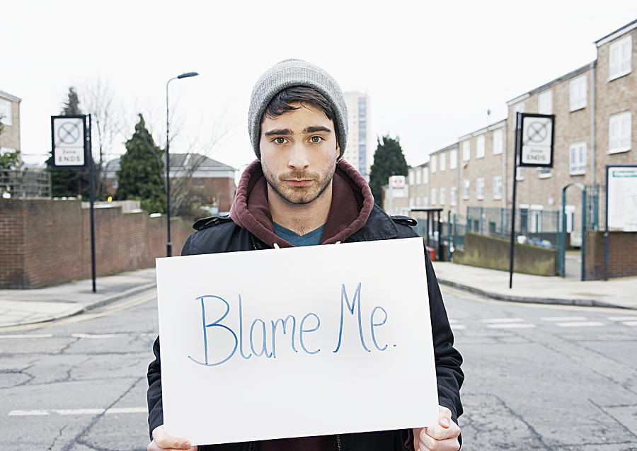Young Man Holding Sign In Urban Street Photograph by Tara Moore
