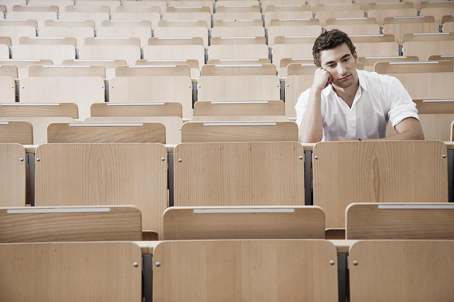 Young man in lecture hall Photograph by Oliver Rossi