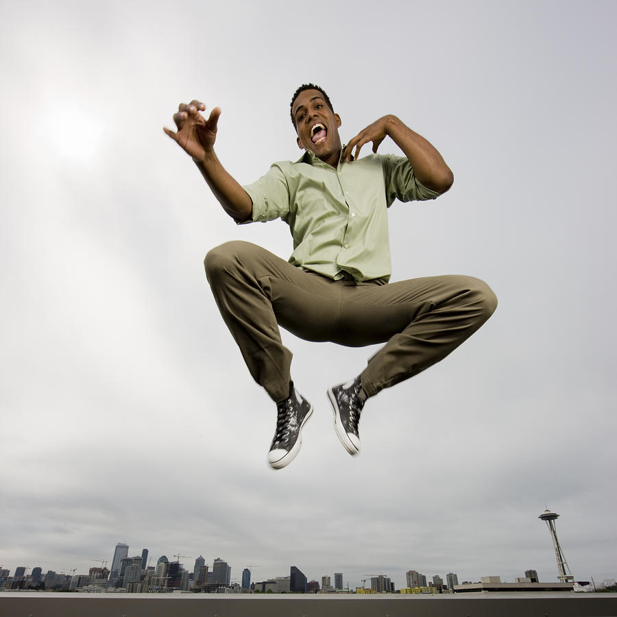 Young man jumping joyfull Photograph by Mlenny