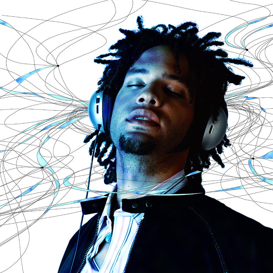 Young man listening to music on headphones (Digital Composite) Photograph by Chad Baker/Ryan McVay