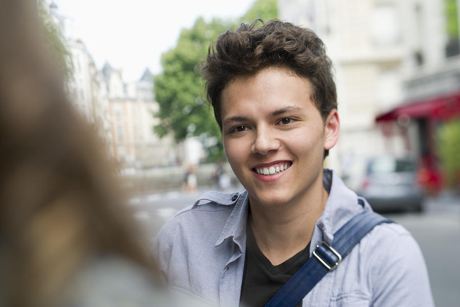 Young man outdoors, smiling Photograph by PhotoAlto/Frederic Cirou