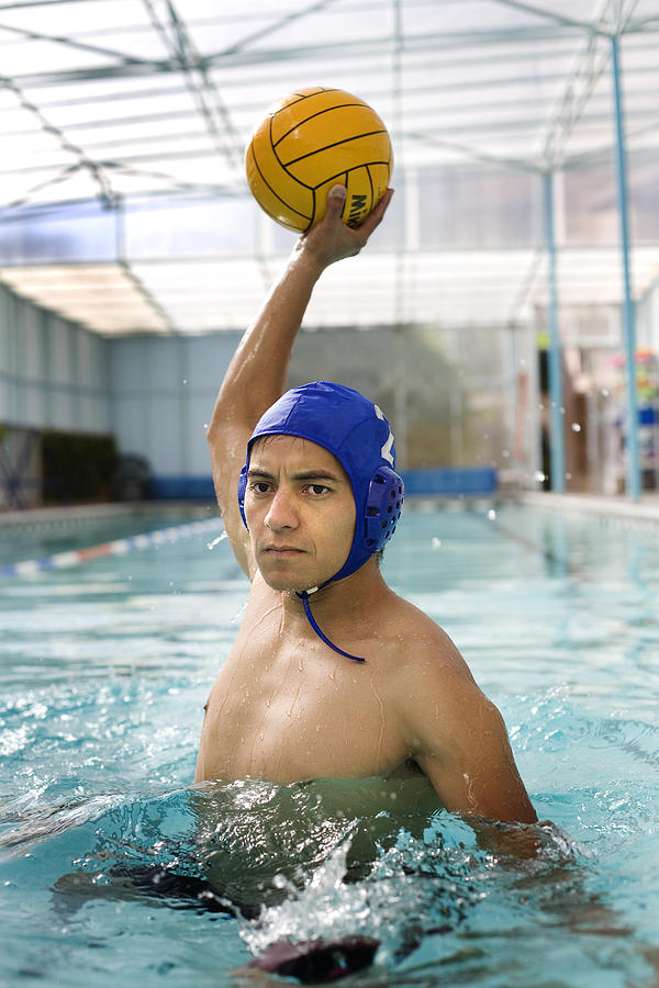 Young man playing water polo Photograph by Rawfile Redux