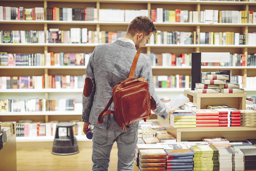Young man shopping books Photograph by Eva-Katalin