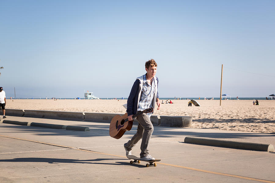 Young man skateboarding, Santa Monica Pier, Santa Monica Beach, US Photograph by Russ Quackenbush