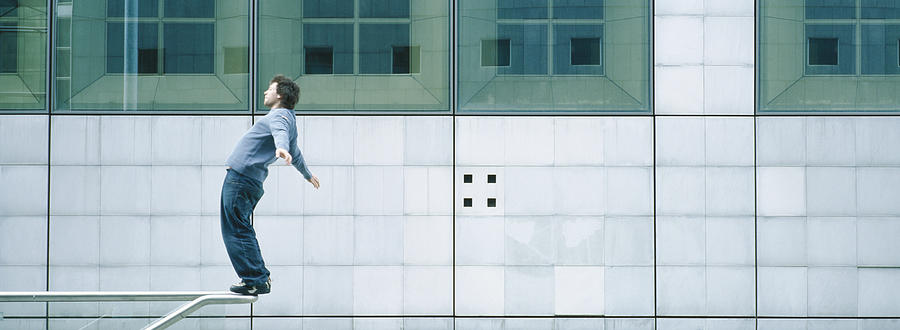 Young man standing on rail Photograph by Matthieu Spohn