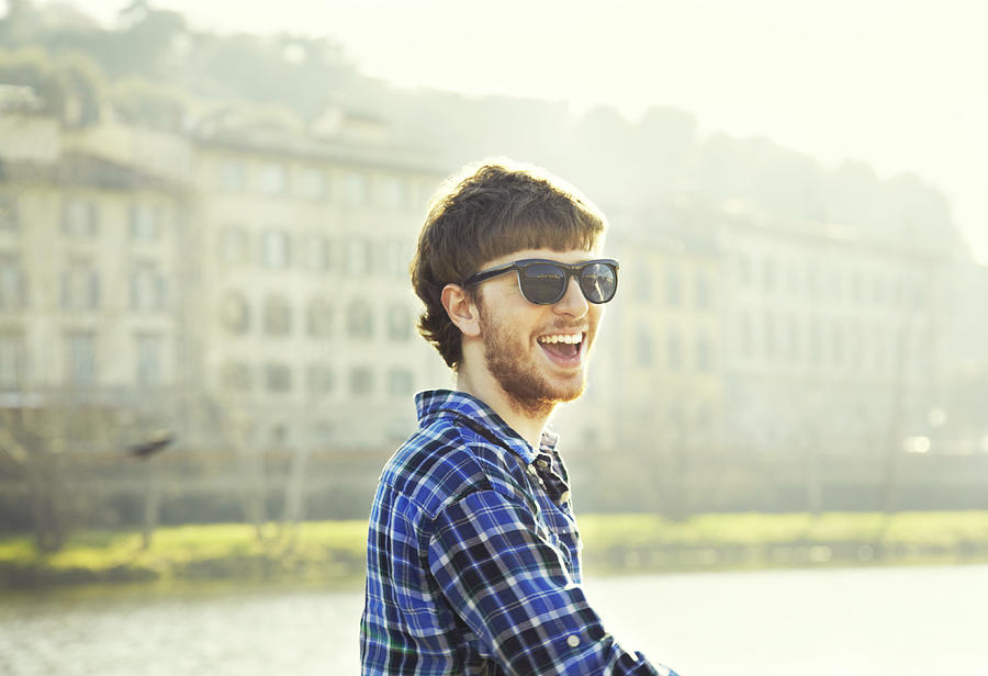 Young man, sunglasses, smiling Photograph by Emma Innocenti