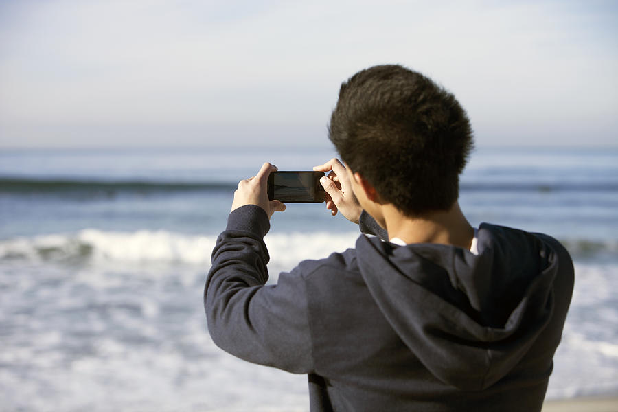 Young man taking photo,video with smart phone Photograph by Eternity in an Instant