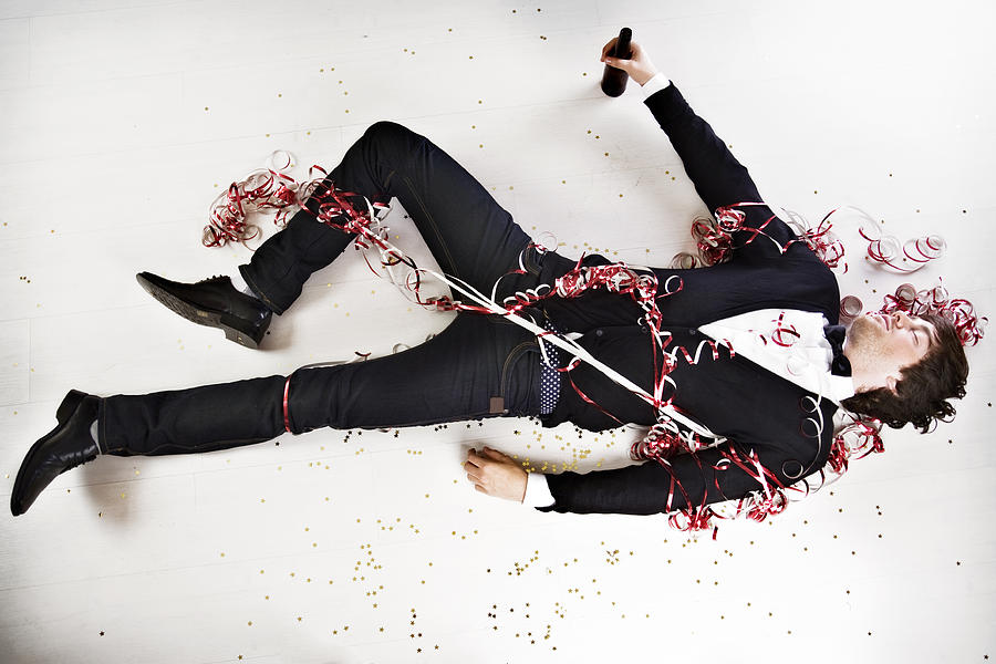 Young Man Wearing Tuxedo Sleeping and Lying on Party Floor Photograph by Orbon Alija