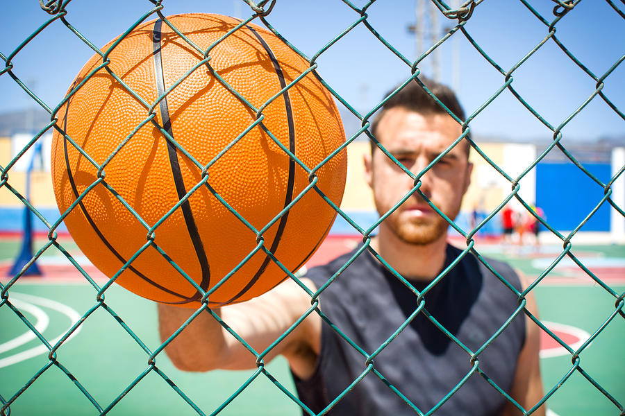 Young Man With The Basketball Behind A Fence Photograph by Etorres69