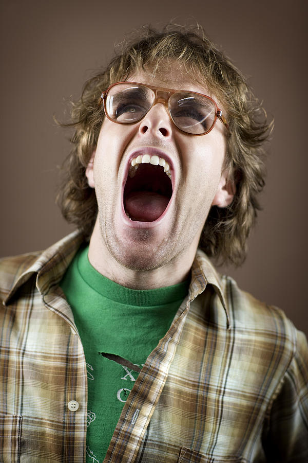 Young man yelling, close-up Photograph by David Sacks