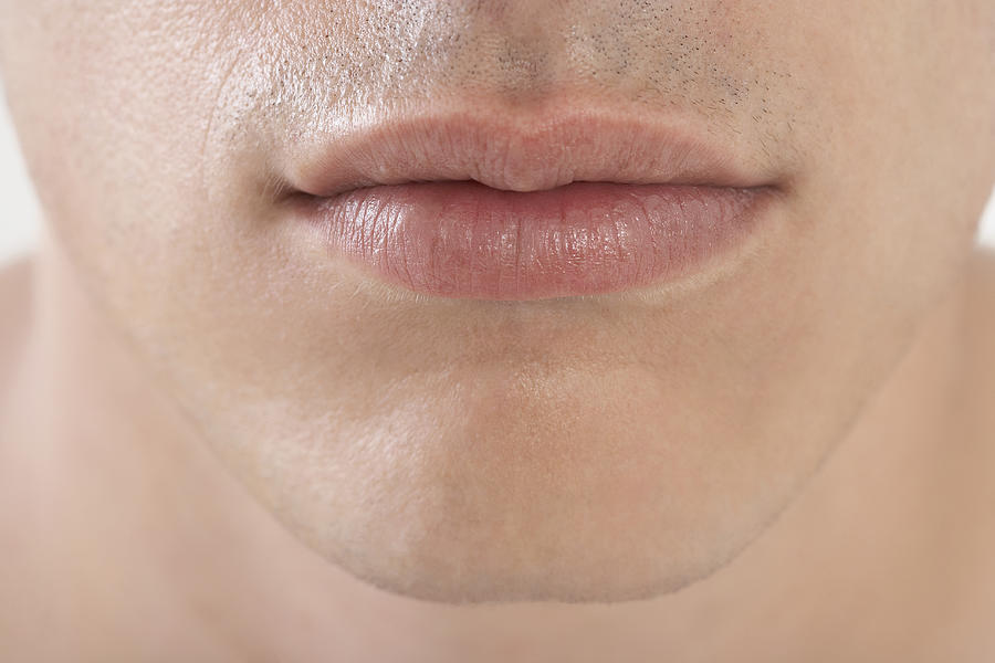 Young mans lips, close-up Photograph by Feliz Aggelos