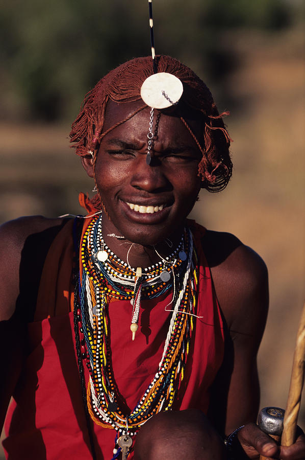 Young Masai posing outdoors, Masai Mara National Reserve, Kenya, portrait Photograph by Anup Shah
