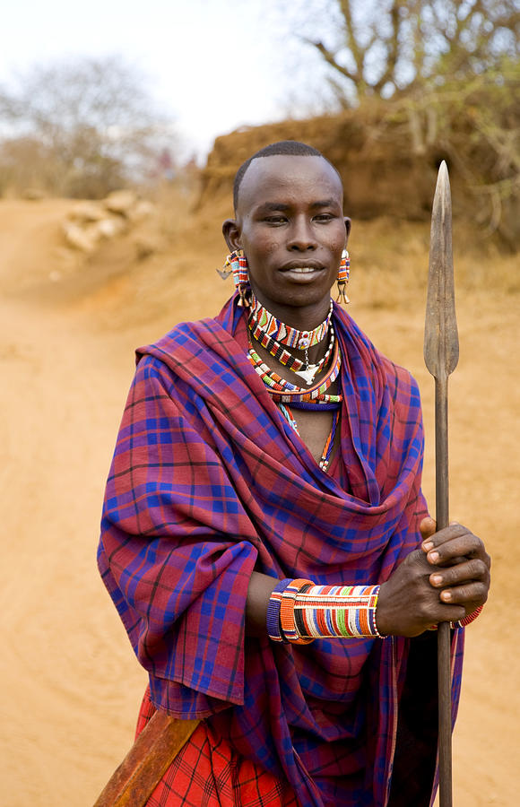 Young Masai warrior with spear and traditional dress, Kenya. Photograph by Brittak