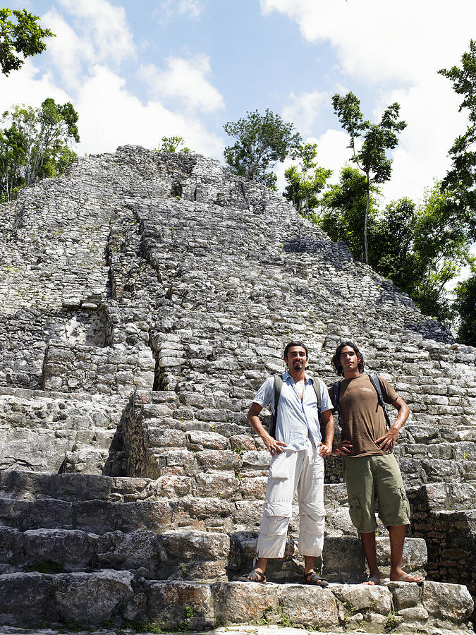 Young men standing on steps of ruins Photograph by Jim Franco