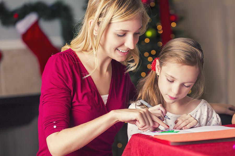 Young mom helping daughter make Christmas greeting cards Photograph by SDI Productions