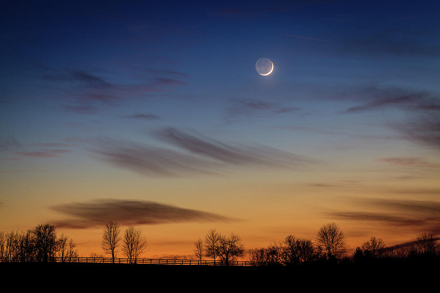 Young moon over countryside Photograph by Alexey Stiop