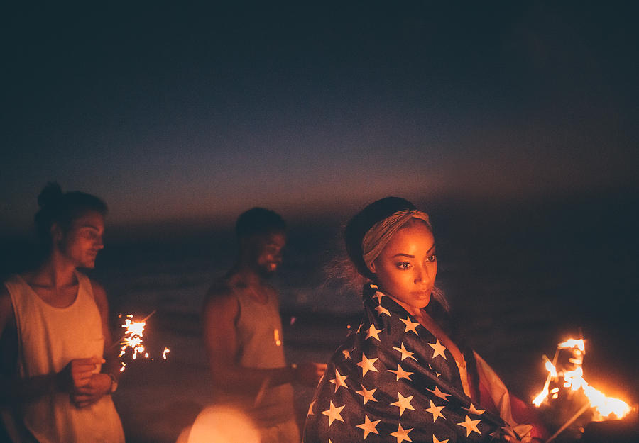 Young multi-ethnic hipster friends celebrating fourth of July with sparklers Photograph by Wundervisuals