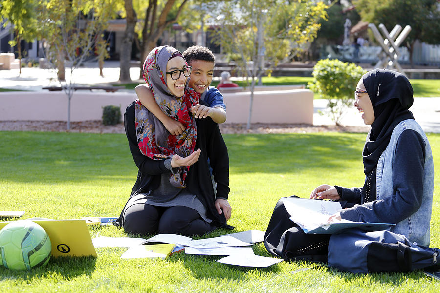 Young Muslim American mother enjoying time with her children in the park Photograph by Mireya Acierto