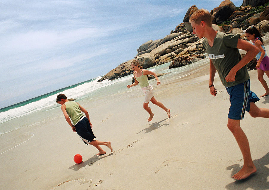 Young people playing soccer at the beach Photograph by Patrick Sheandell OCarroll