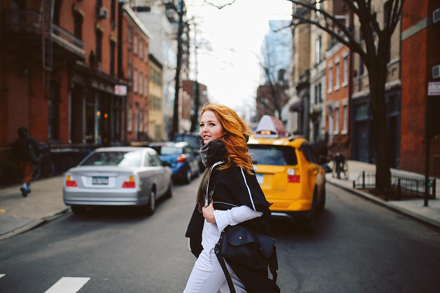 Young redhead woman walking on the streets of West Village, Manhattan, NY Photograph by Lechatnoir