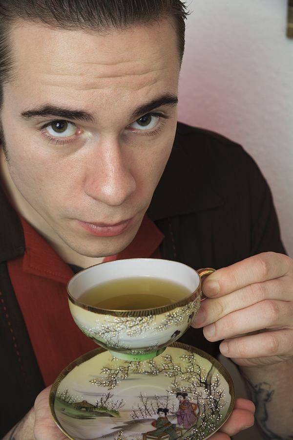 Young rockabilly man drinking tea Photograph by Junophoto