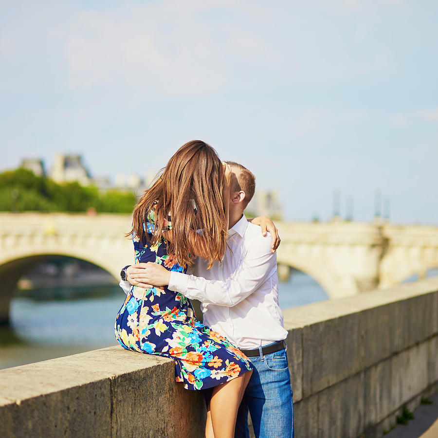 Young romantic couple on the Seine embankment Photograph by Encrier