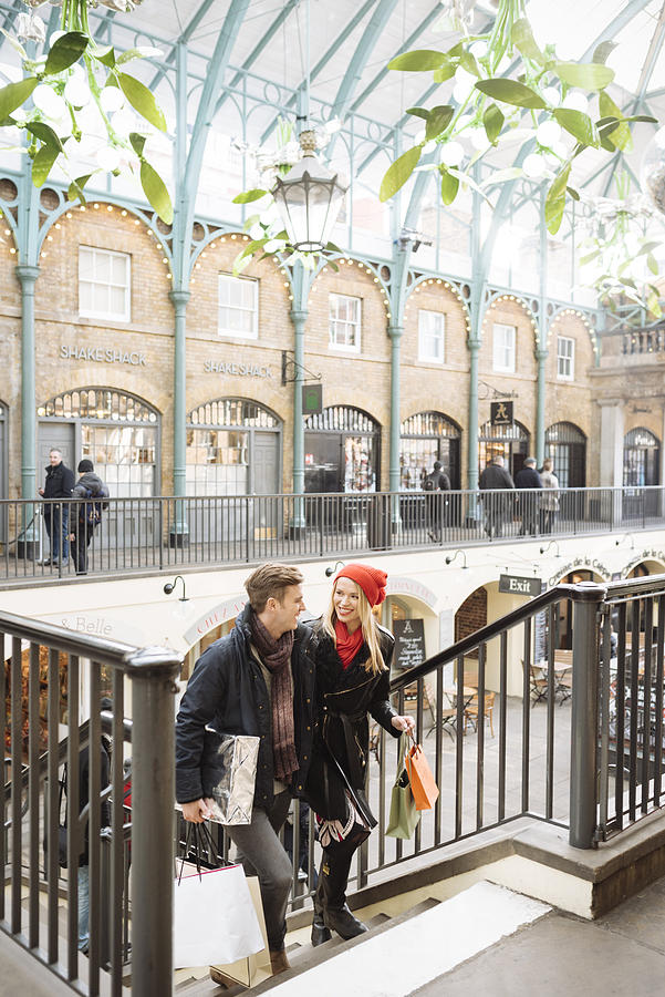 Young shopping couple on stairway in Covent Garden, London, UK Photograph by Ben Pipe Photography
