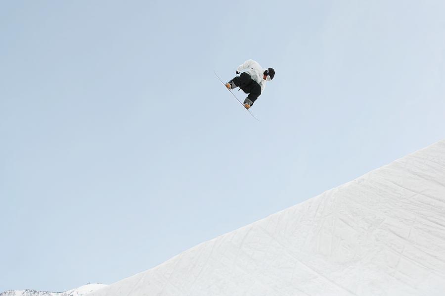 Young snowboarder airborne Photograph by Masakazu Watanabe