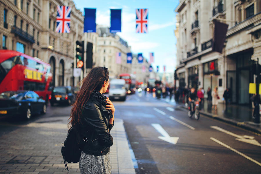 Young woman crossing the street in Central London Photograph by Lechatnoir