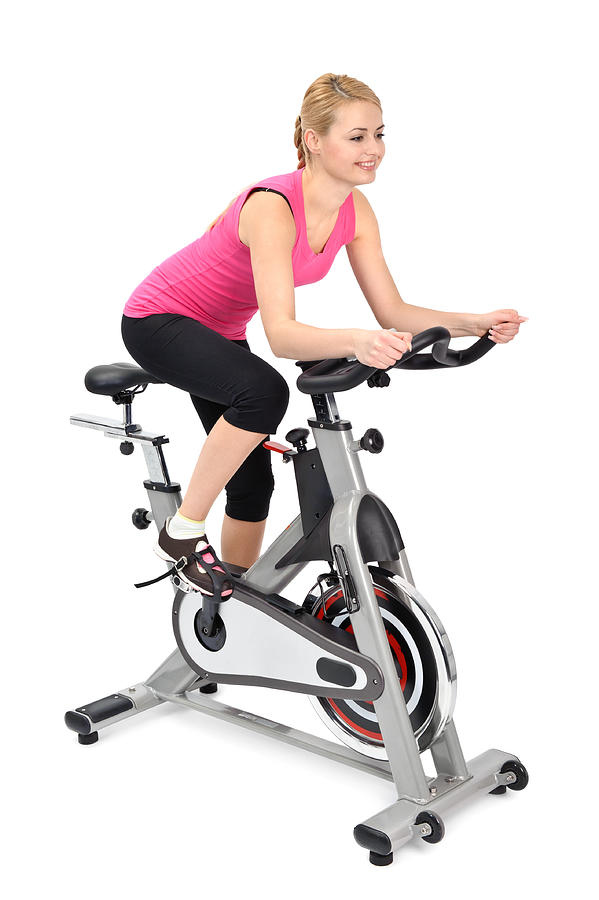 Young Woman Doing Indoor Biking Exercise Photograph by Starush