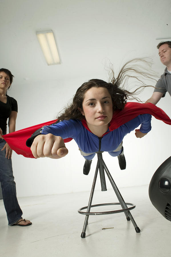 Young woman dressed as superwoman, in studio Photograph by Photodisc