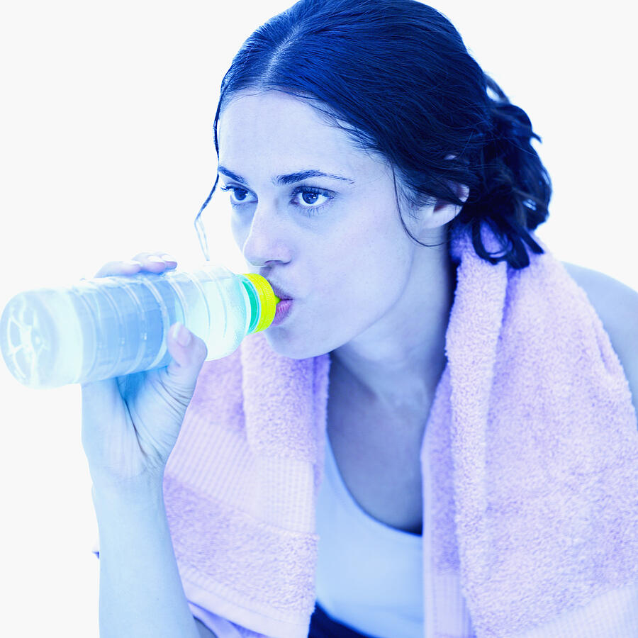 Young woman drinking water from a bottle Photograph by Stockbyte