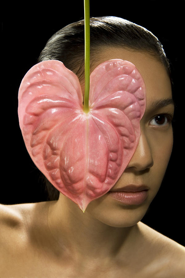 Young woman having eye covered with Anthurium flower Photograph by Scott Kleinman