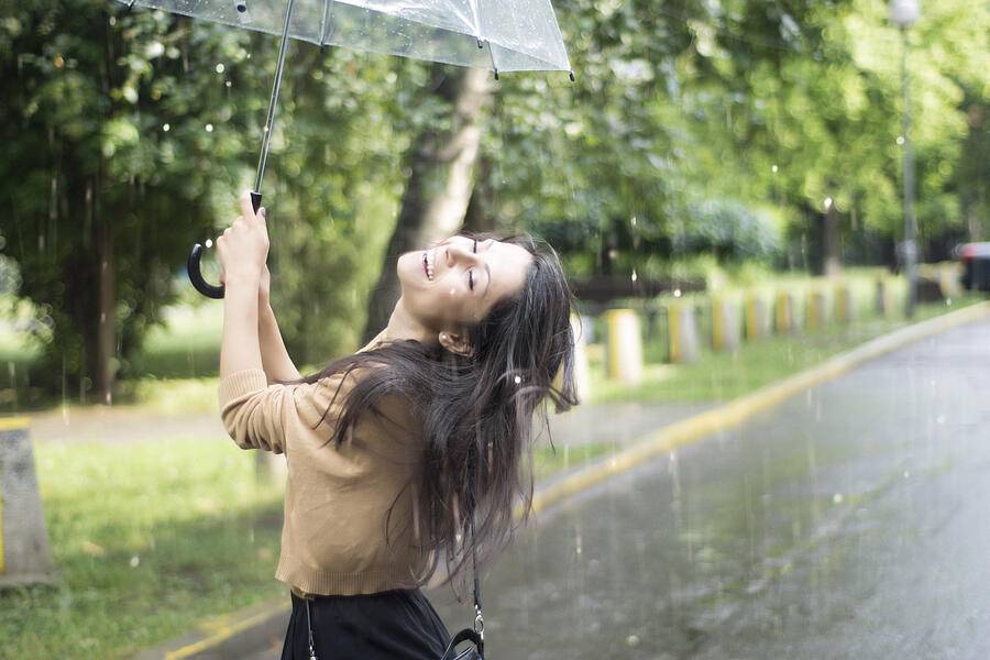 Young woman having fun in the rain Photograph by Kotijelly