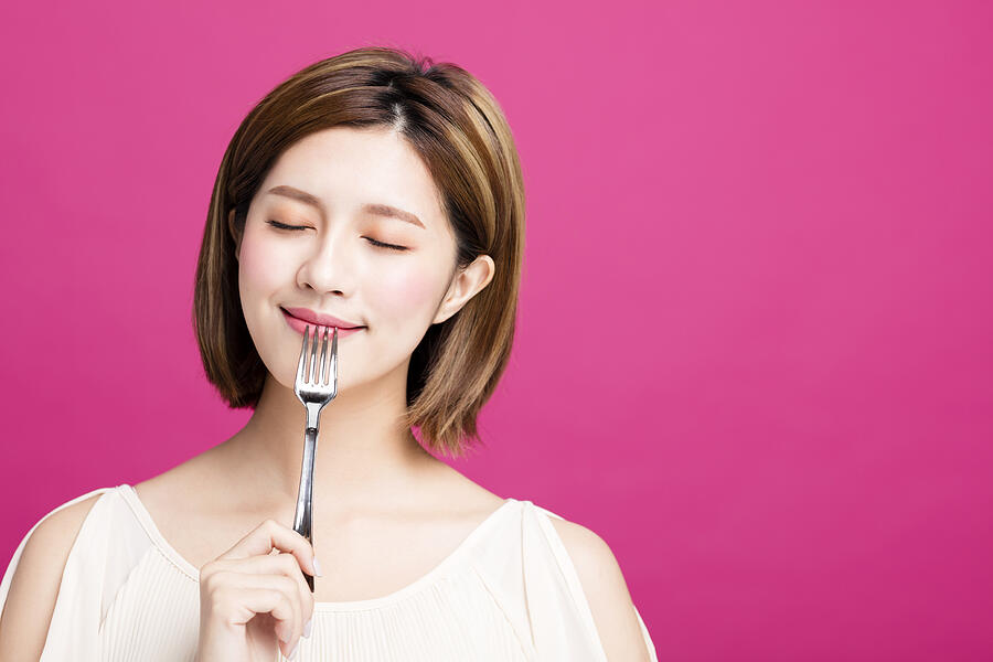 Young Woman Holding Fork And Enjoy Tasty Food Photograph by Tomwang112