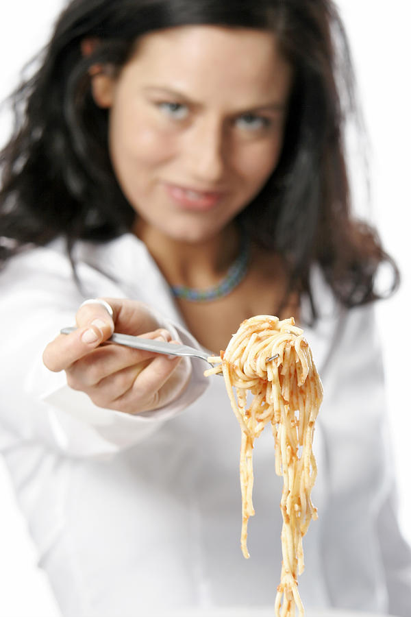 Young woman holding fork with Spaghetti Photograph by Loop Delay