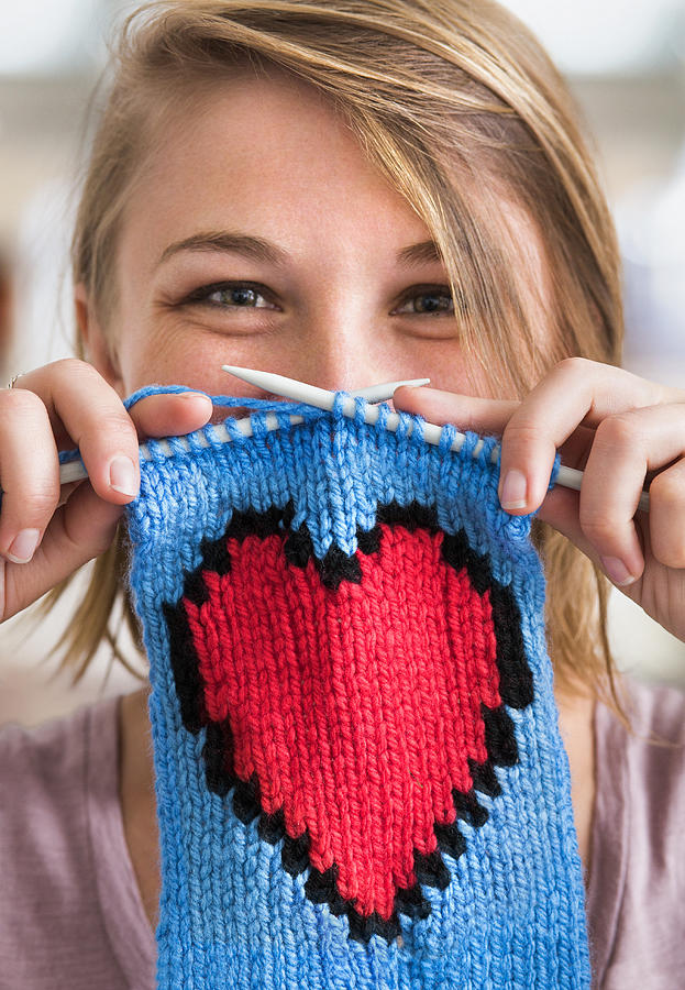 Young woman holding knitted red heart scarf Photograph by Dimitri Otis