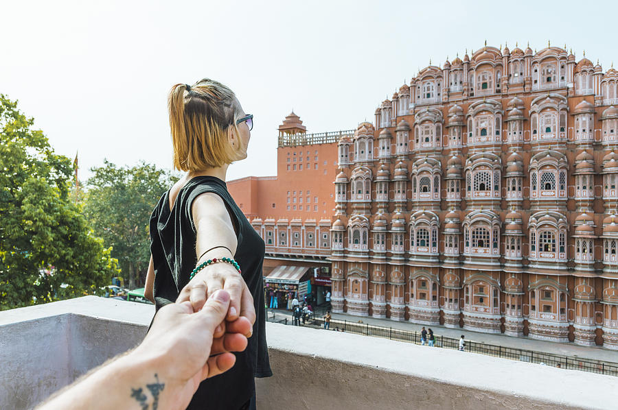 Young woman holds hand above Hawa Mahal Photograph by Andrii Lutsyk/ Ascent Xmedia
