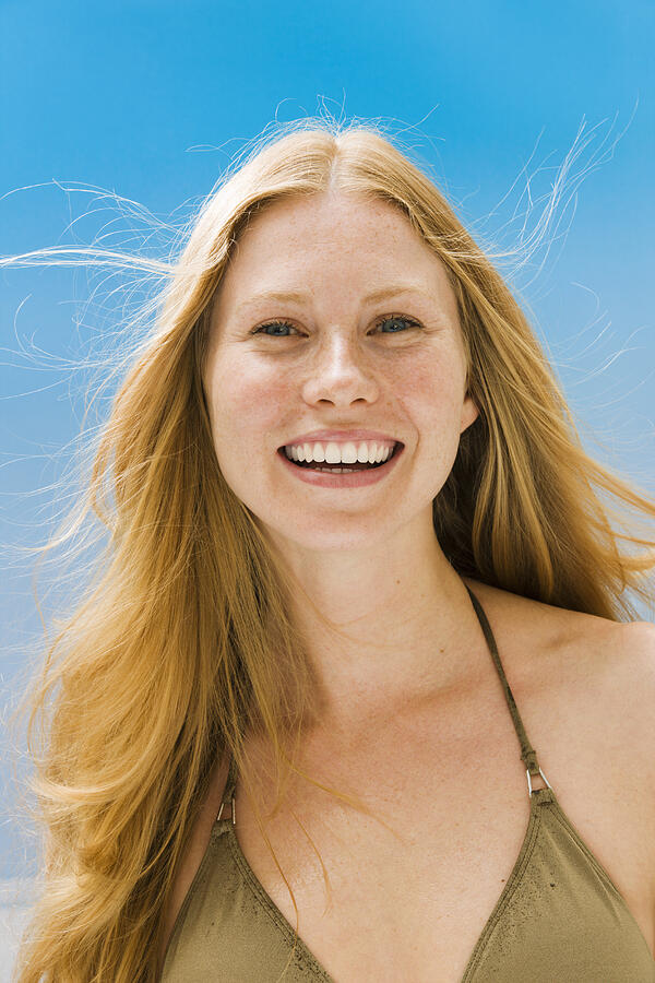 Young woman in bikini top smiling, portrait Photograph by Pando Hall