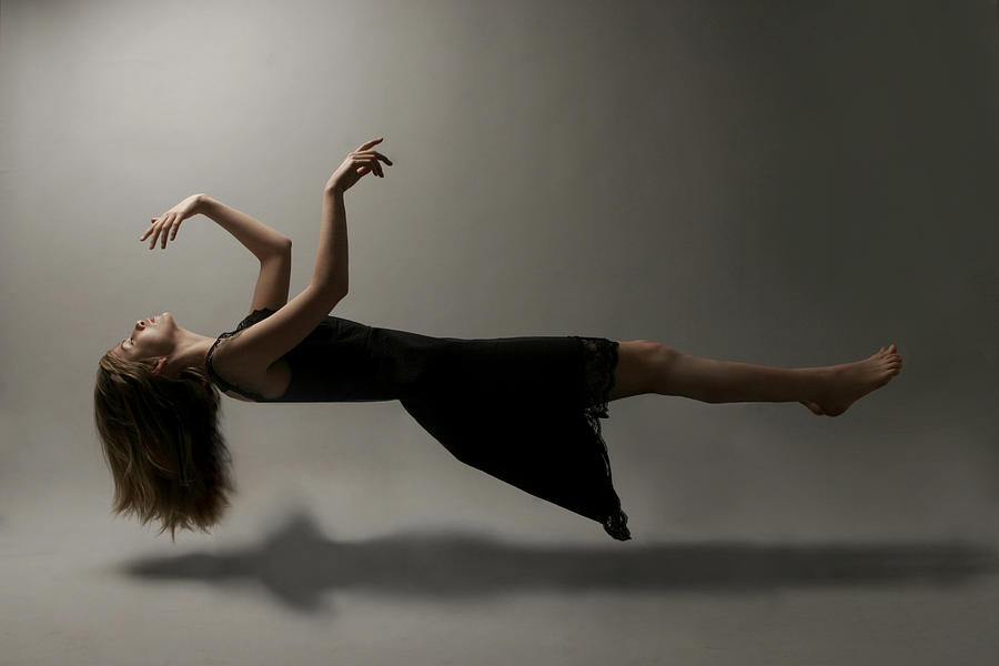 Young woman in mid-air Photograph by Elena Kulikova