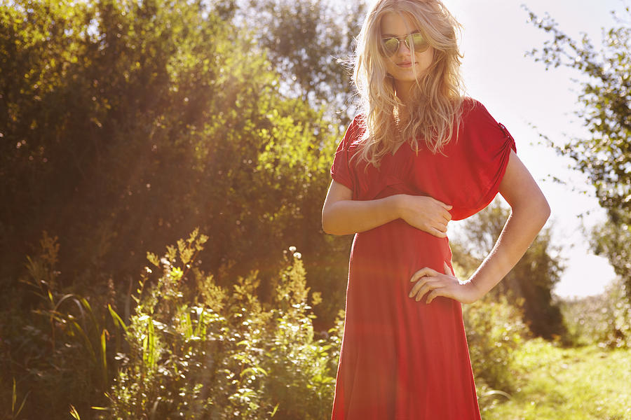 Young woman in nature wearing red dress Photograph by Marcus Lund