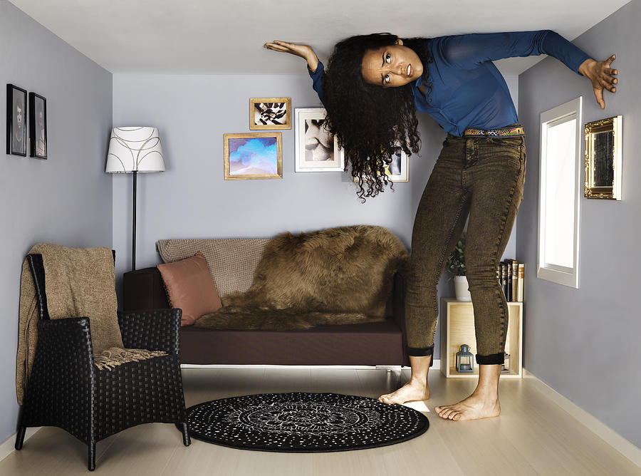 Young Woman In Small Scale Living Room Photograph by Henrik Sorensen