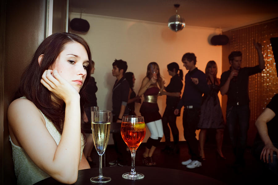 Young Woman Is Sitting Alone In A Nightclub Photograph by Nullplus