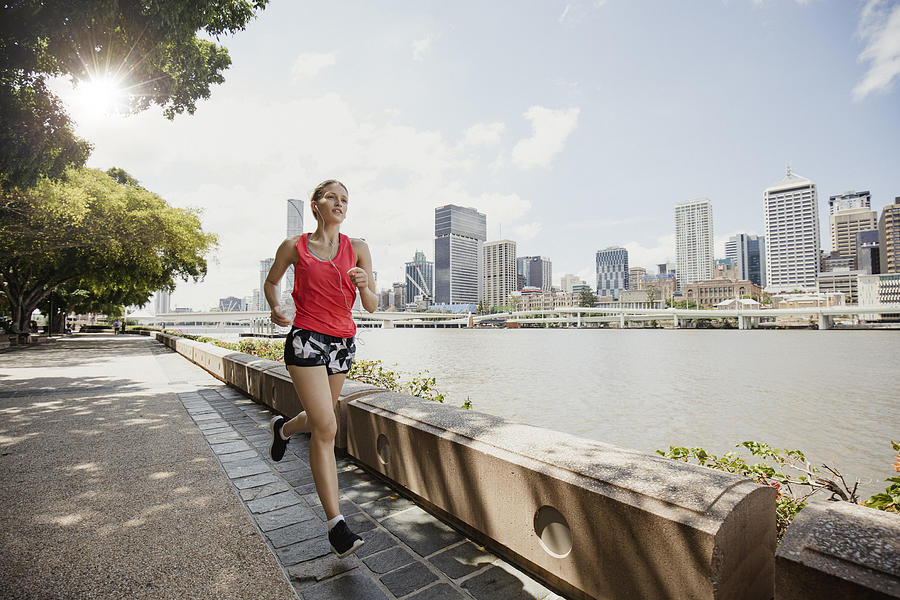 Young Woman Jogging on Brisbane Southbank Photograph by SolStock